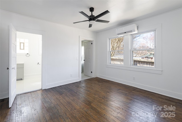 unfurnished bedroom with a wall unit AC, baseboards, dark wood-type flooring, and ceiling fan