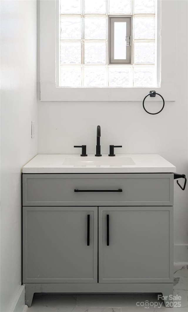 bathroom featuring marble finish floor and vanity