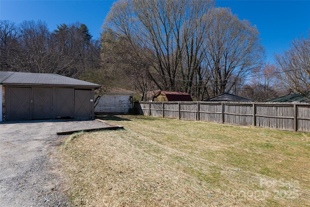 view of yard featuring an outdoor structure and fence