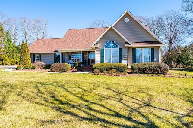 ranch-style house with a front yard, brick siding, and a shingled roof