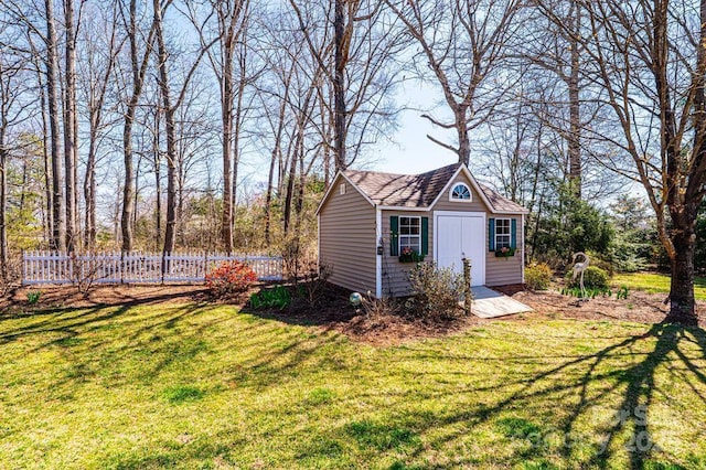 view of outbuilding with an outbuilding and fence