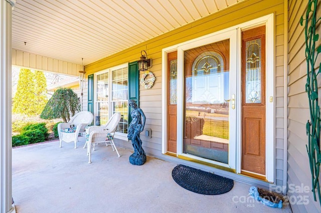 view of exterior entry featuring a porch