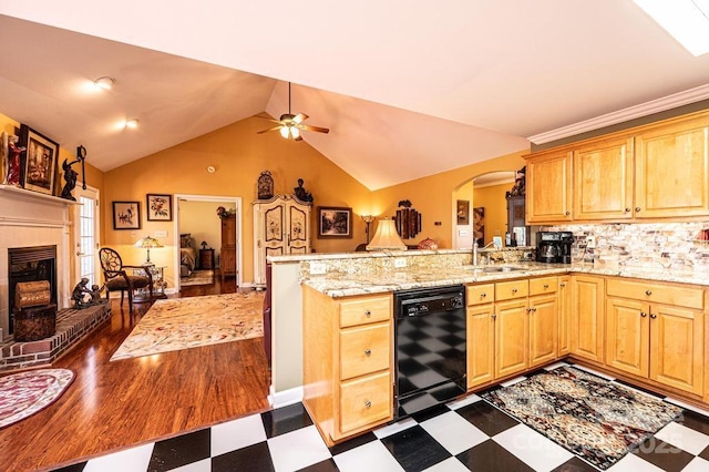 kitchen featuring a brick fireplace, dark floors, dishwasher, a peninsula, and a sink