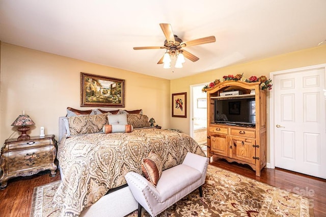 bedroom with ensuite bathroom, ceiling fan, and dark wood-style flooring