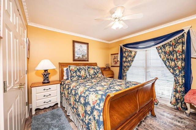 bedroom with a ceiling fan, wood finished floors, and crown molding