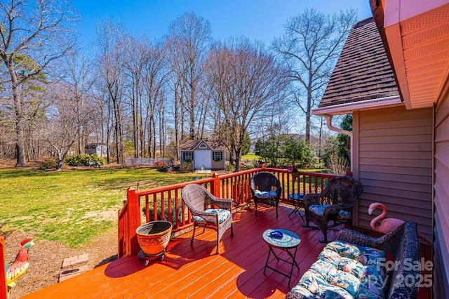 wooden deck featuring an outbuilding and a lawn