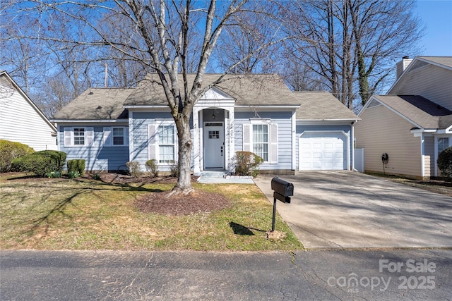 view of front of property featuring concrete driveway, a garage, and a front yard