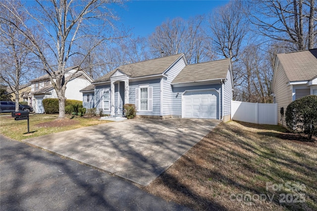 view of front of property with a front lawn, fence, concrete driveway, roof with shingles, and an attached garage