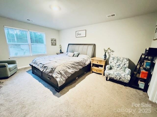 bedroom with baseboards, visible vents, and carpet floors