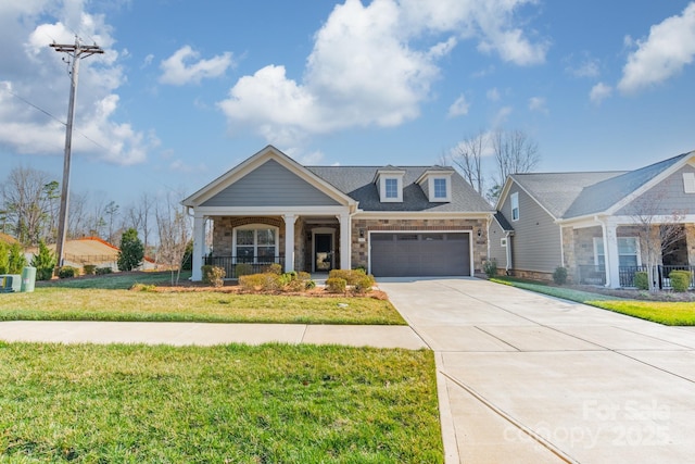 view of front of house with an attached garage, covered porch, concrete driveway, and a front lawn