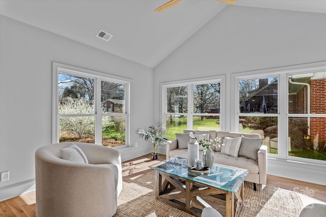 sunroom / solarium featuring visible vents and lofted ceiling