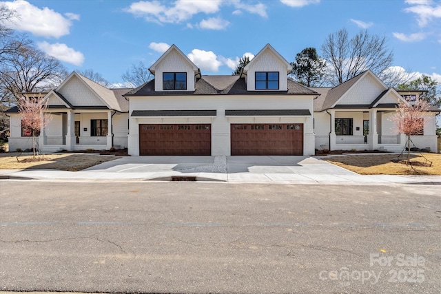 modern inspired farmhouse with a porch and driveway