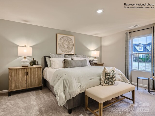 bedroom featuring light colored carpet, visible vents, and baseboards