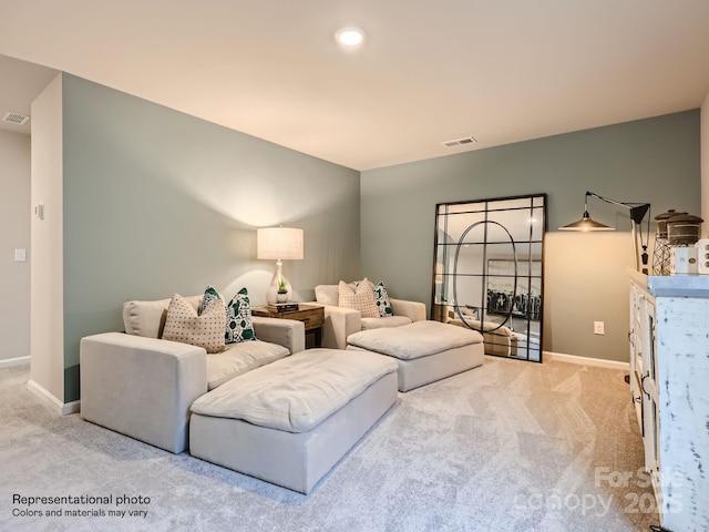 living area featuring recessed lighting, visible vents, light carpet, and baseboards