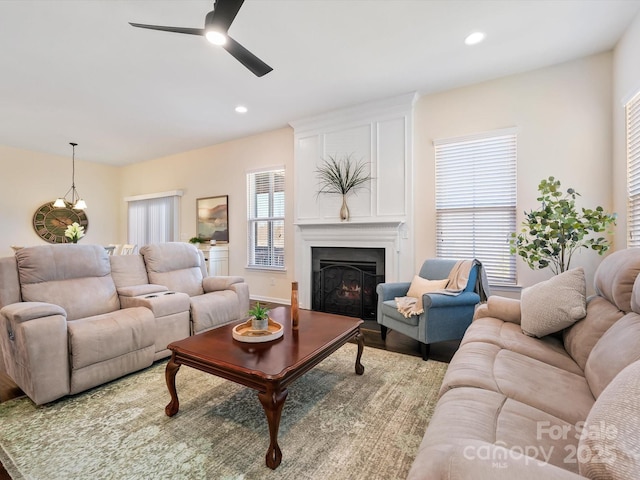 living room featuring a fireplace, wood finished floors, recessed lighting, and a ceiling fan