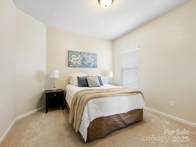 carpeted bedroom featuring baseboards