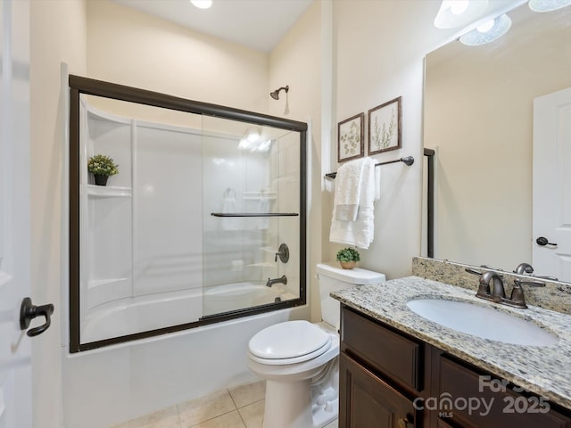 full bathroom featuring tile patterned flooring, toilet, vanity, and shower / bath combination with glass door