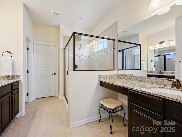 full bath with vanity, visible vents, baseboards, a stall shower, and tile patterned floors