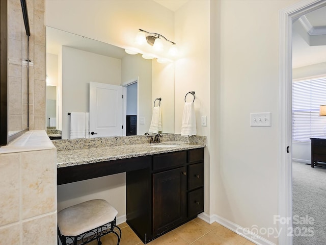 bathroom with vanity, tile patterned floors, and baseboards