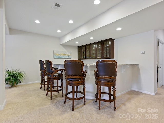 bar with visible vents, recessed lighting, light colored carpet, and baseboards