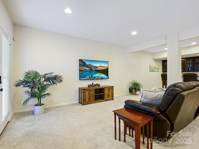 carpeted living room with recessed lighting and baseboards