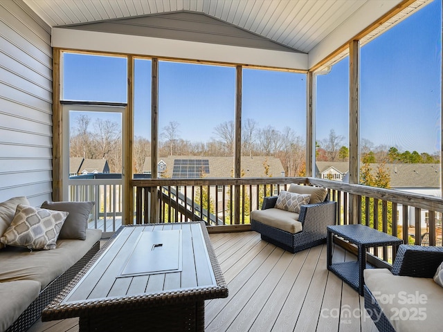 sunroom / solarium with vaulted ceiling and a healthy amount of sunlight