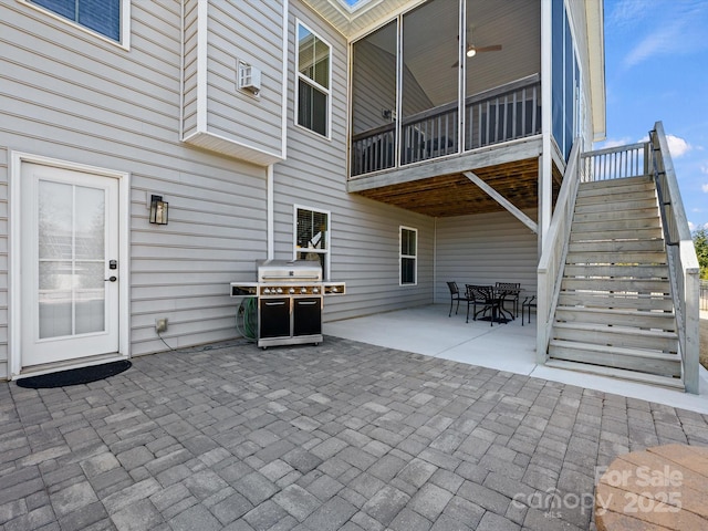 view of patio featuring a grill, an AC wall unit, and stairs