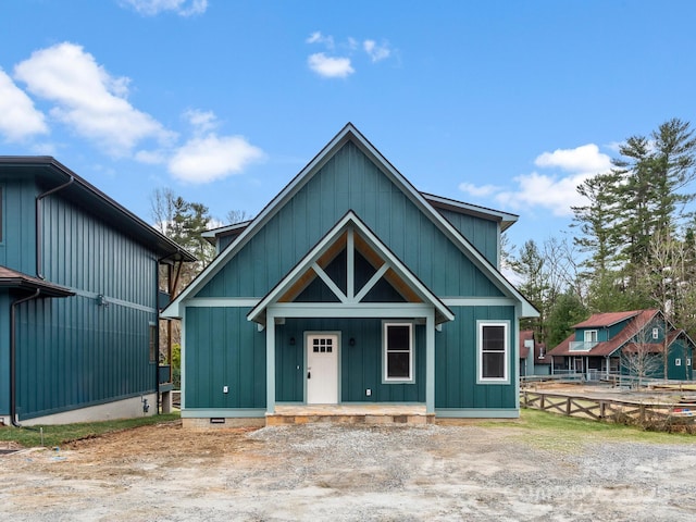 view of front of house featuring fence, covered porch, and crawl space