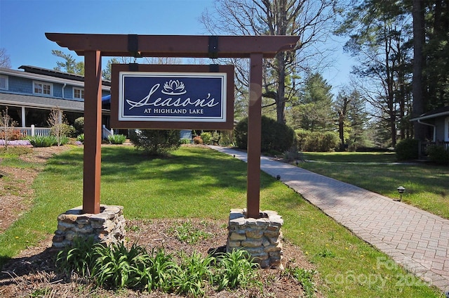 community / neighborhood sign with a lawn