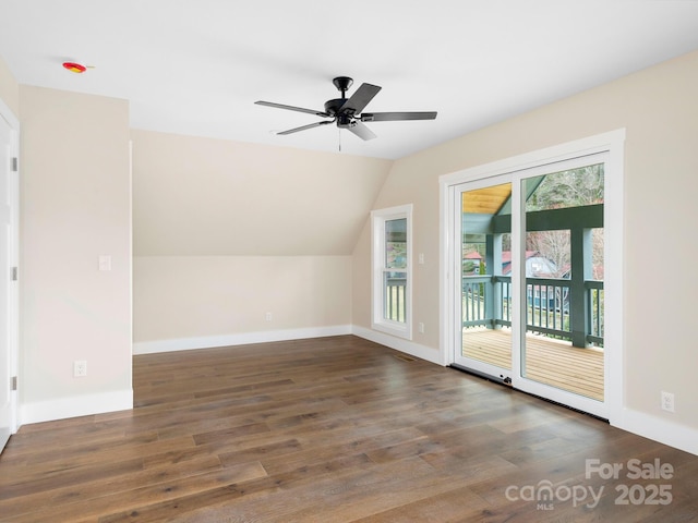 additional living space with ceiling fan, baseboards, wood finished floors, and vaulted ceiling