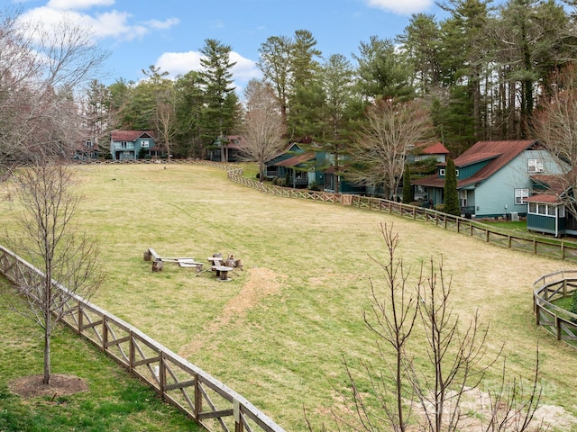 view of yard with an outdoor fire pit and fence