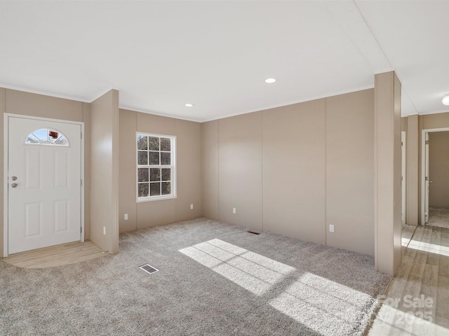 entryway with recessed lighting, visible vents, and carpet flooring