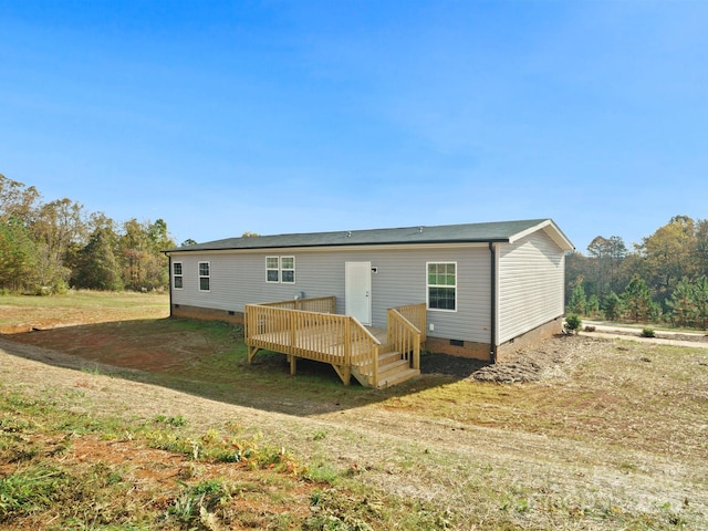 back of property featuring a deck and crawl space