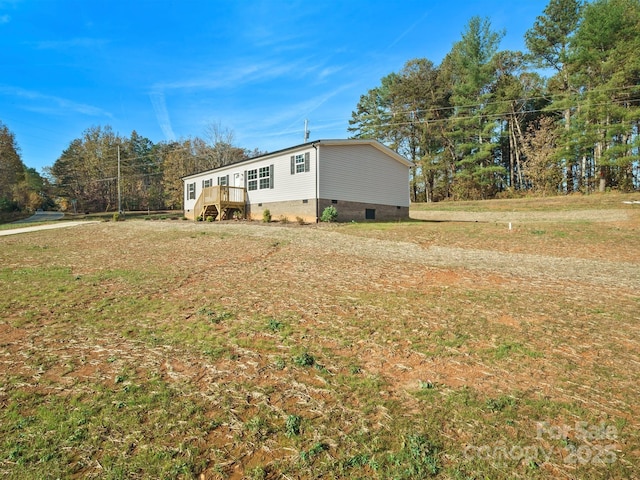 exterior space with crawl space and a front yard