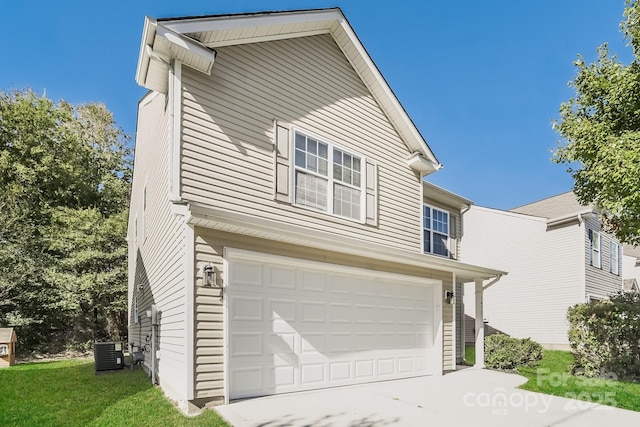 exterior space featuring driveway, central AC unit, and an attached garage