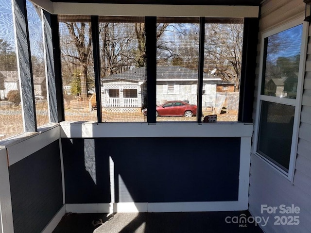 unfurnished sunroom with a wealth of natural light