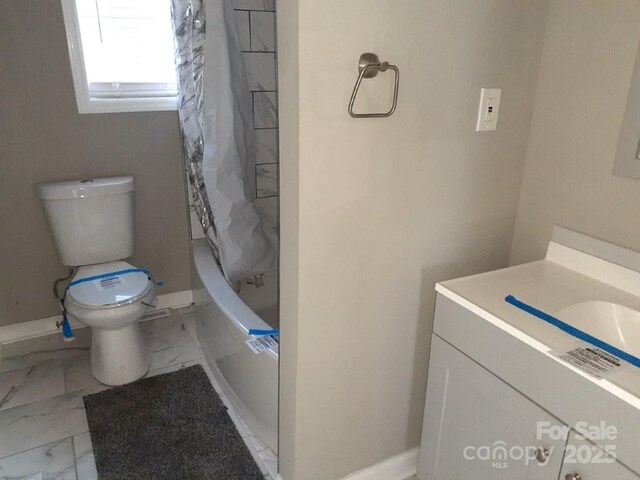 bathroom with vanity, baseboards, shower / bath combination with curtain, toilet, and marble finish floor