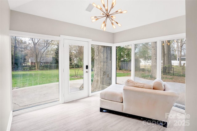 sunroom featuring an inviting chandelier