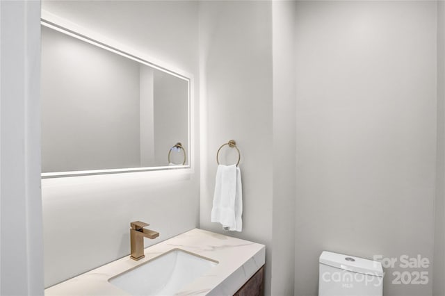 bathroom featuring toilet and vanity