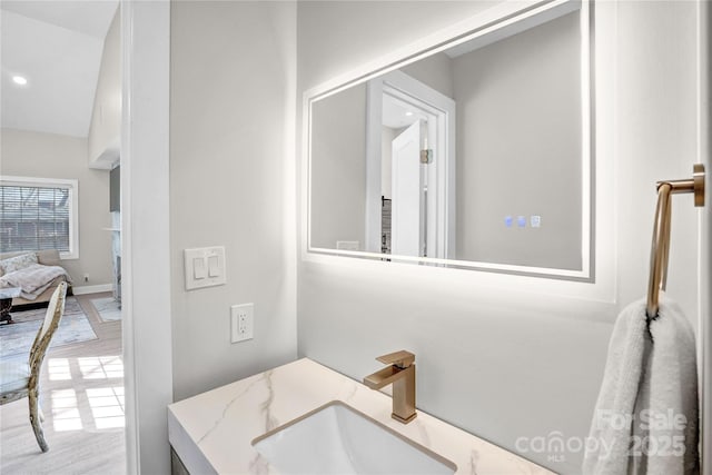 bathroom featuring recessed lighting and a sink