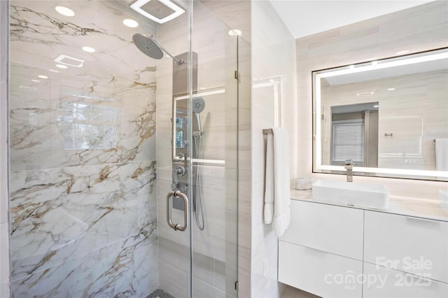 full bath with vanity and a stall shower