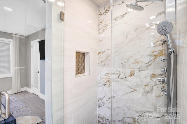 bathroom featuring a marble finish shower