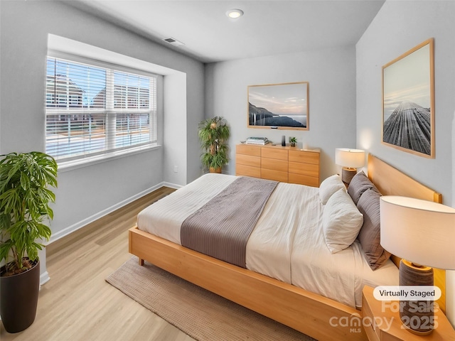 bedroom featuring visible vents, recessed lighting, baseboards, and wood finished floors