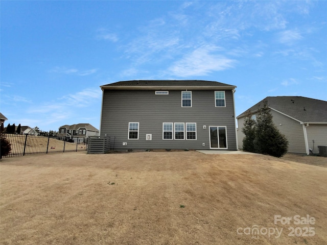 back of property featuring a patio and fence