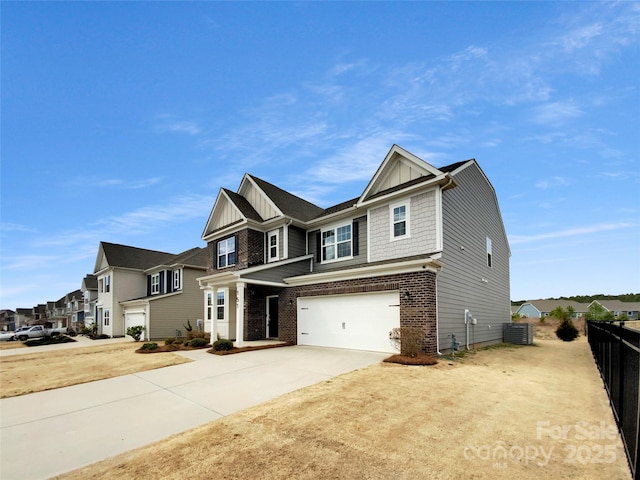 view of front of house with central AC unit, board and batten siding, driveway, and a garage