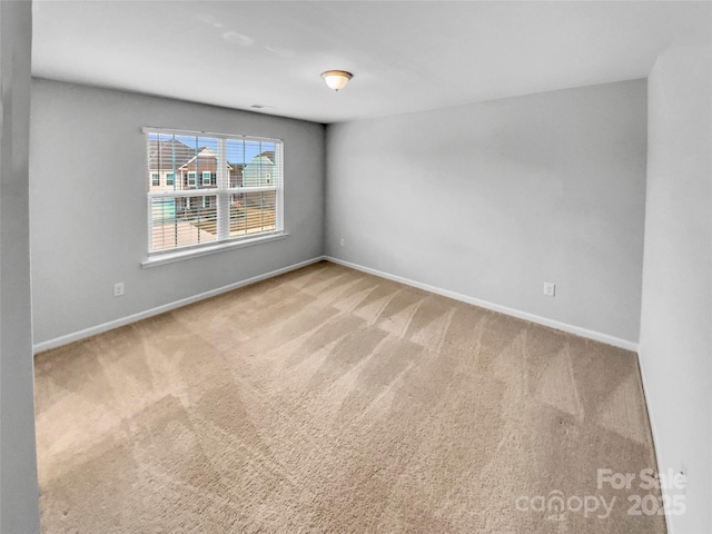 empty room with carpet flooring and baseboards