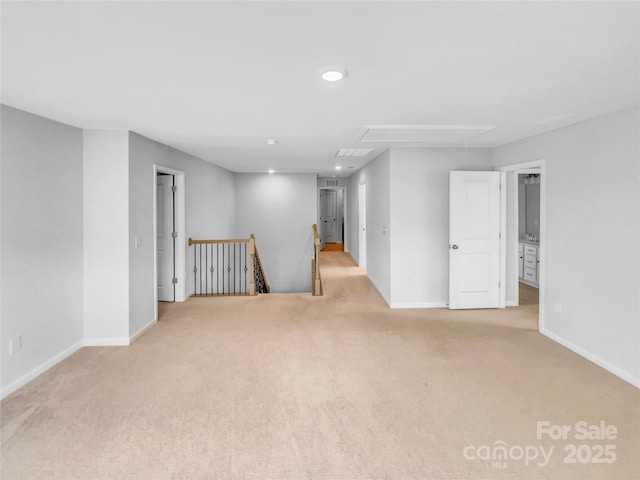 carpeted empty room featuring attic access, recessed lighting, and baseboards