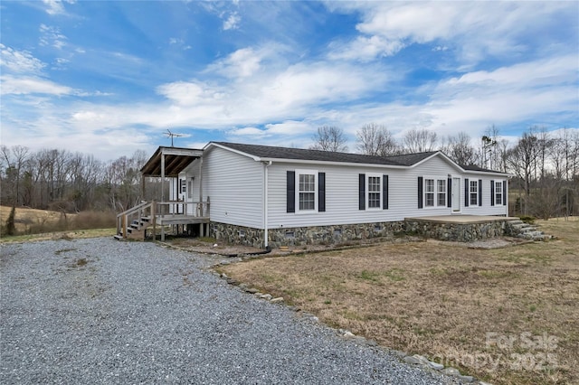 view of side of property with a patio and crawl space