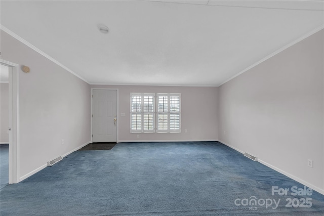 empty room featuring dark colored carpet, visible vents, baseboards, and crown molding