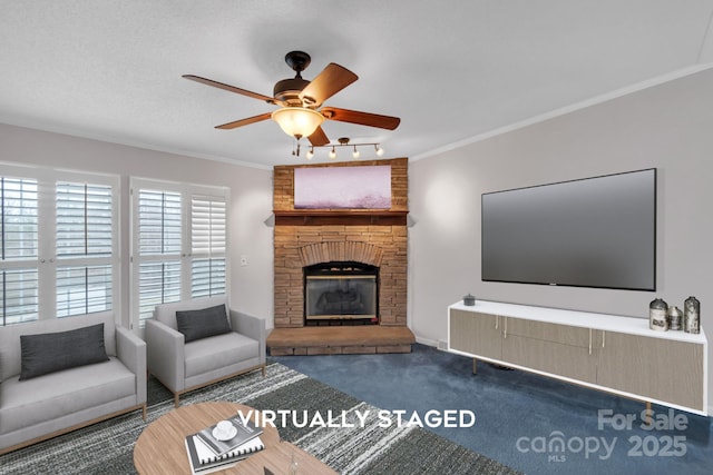 living room with a fireplace, carpet, crown molding, and ceiling fan